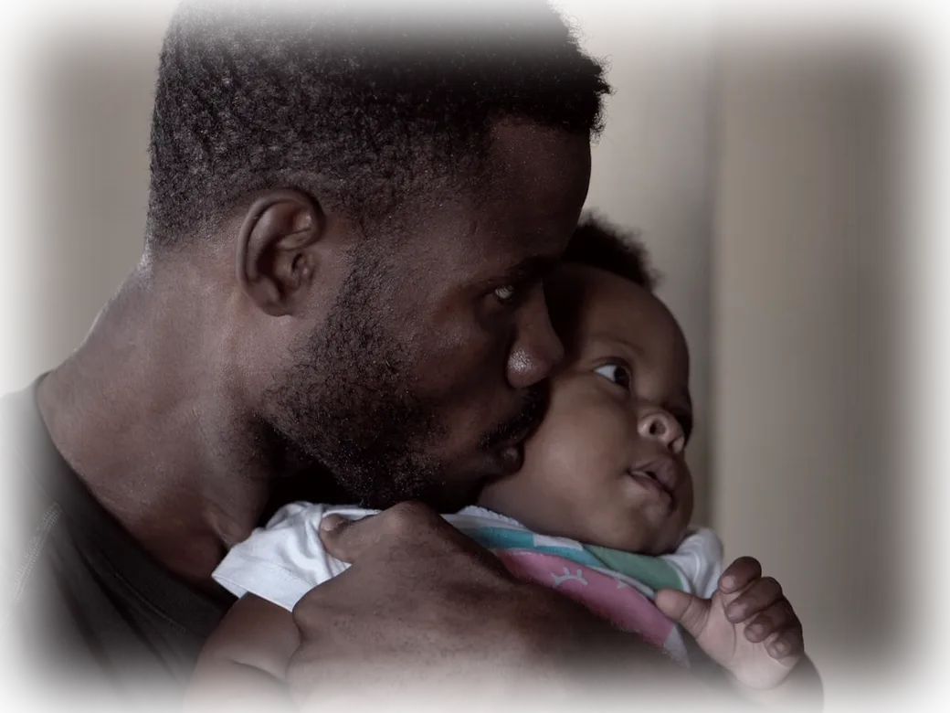 A father holding his baby close
