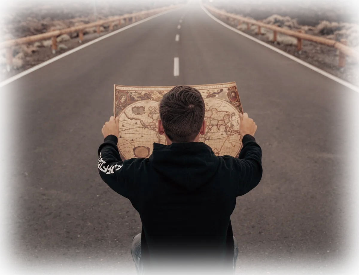 A person reading a map on an open road